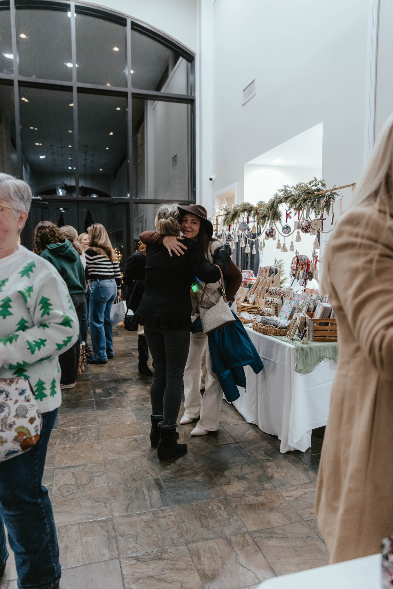 Guests browsing vendor tables at the Sip & Sparkle Vendor Holiday Market.