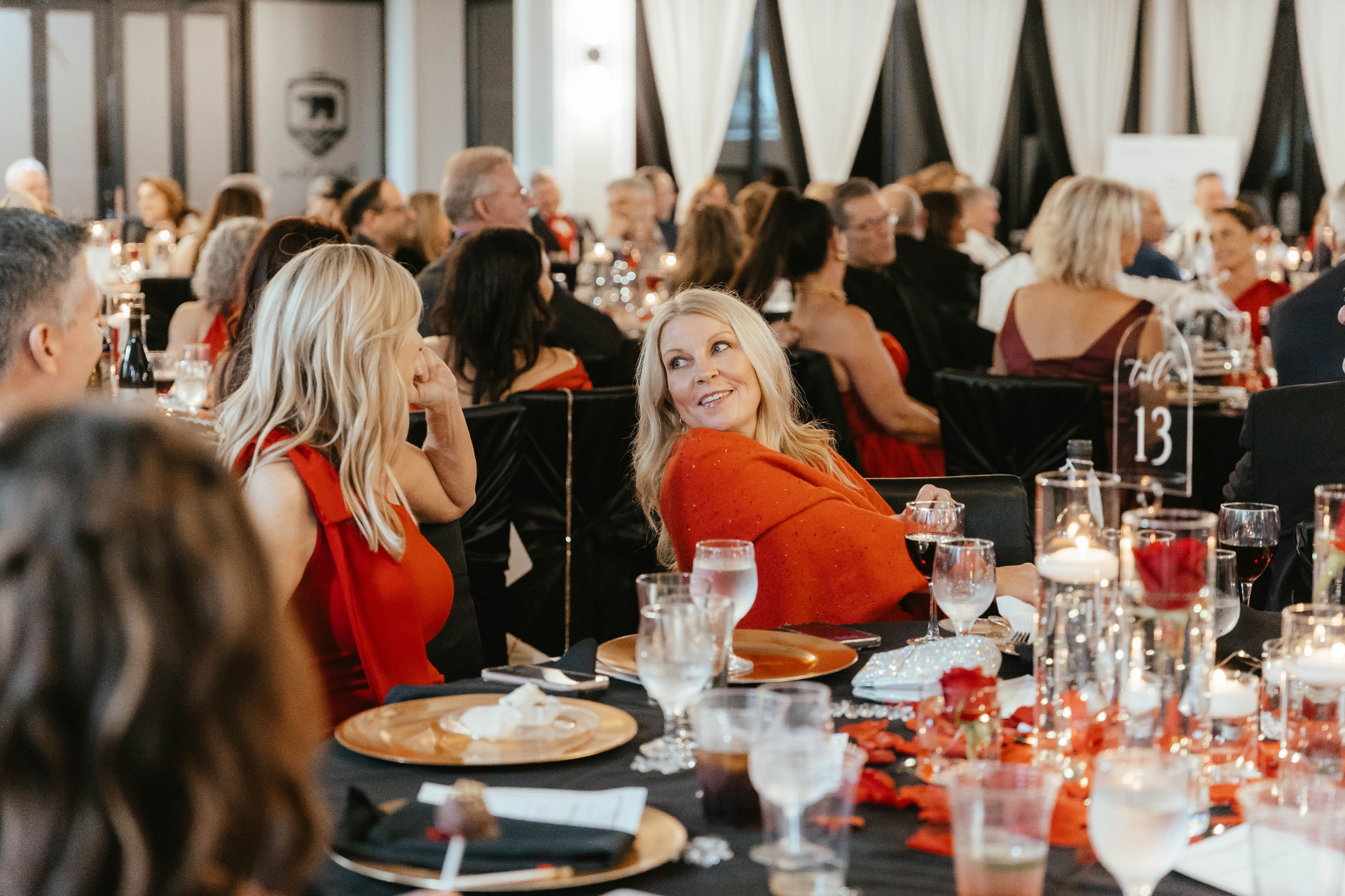 Guests seated at elegantly decorated tables during the Lady in Red Gala.