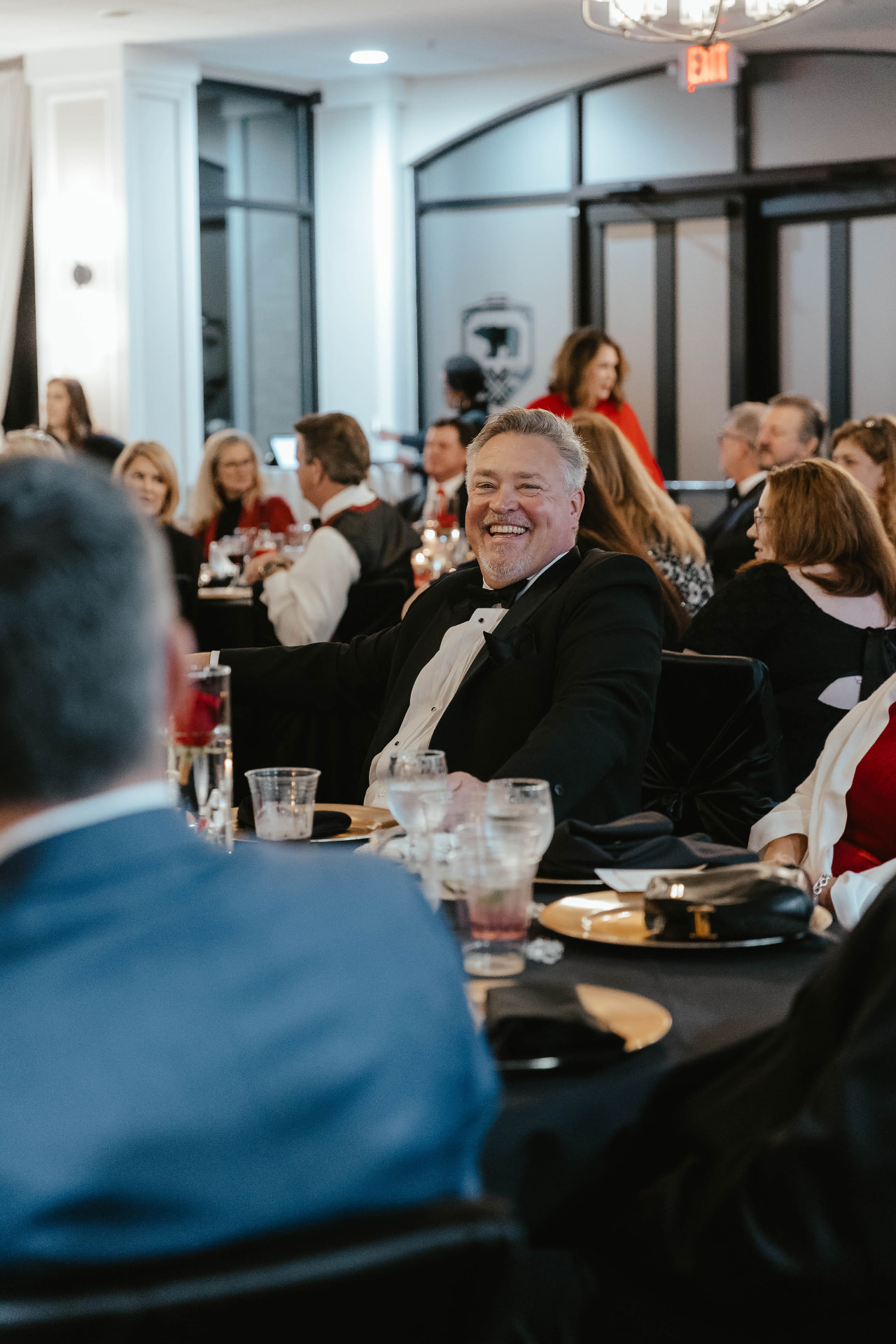 A guest smiling during the Lady in Red Gala program.