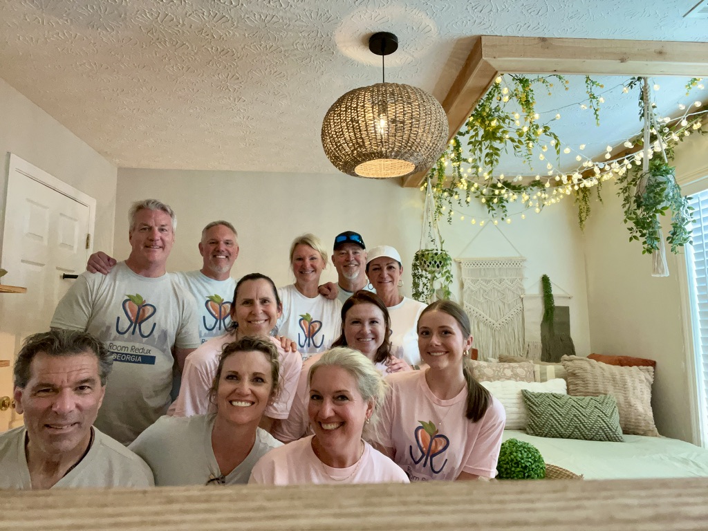 RRGA volunteers gathered inside a completed bedroom.