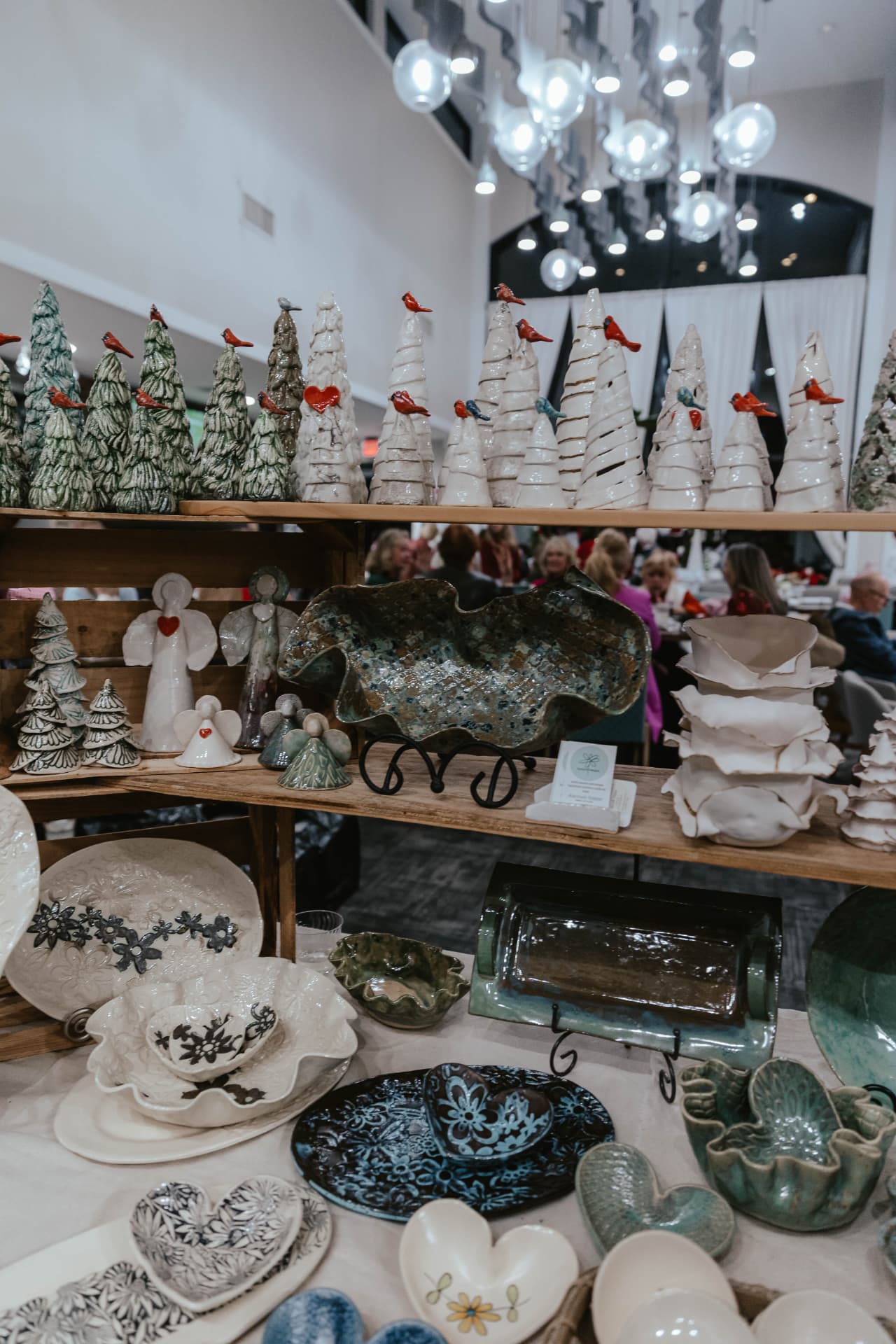 Handmade pottery and ceramic trees displayed at the Sip & Sparkle Vendor Holiday Market.