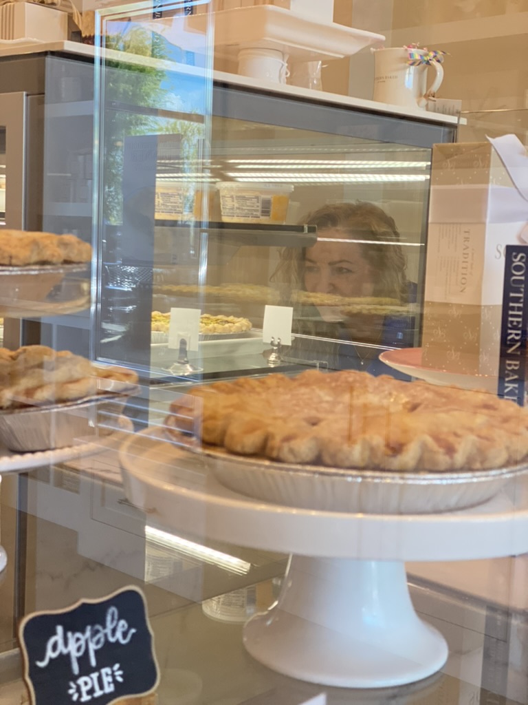 Apple pies on display inside the Southern Baked Pie Company bakery case.