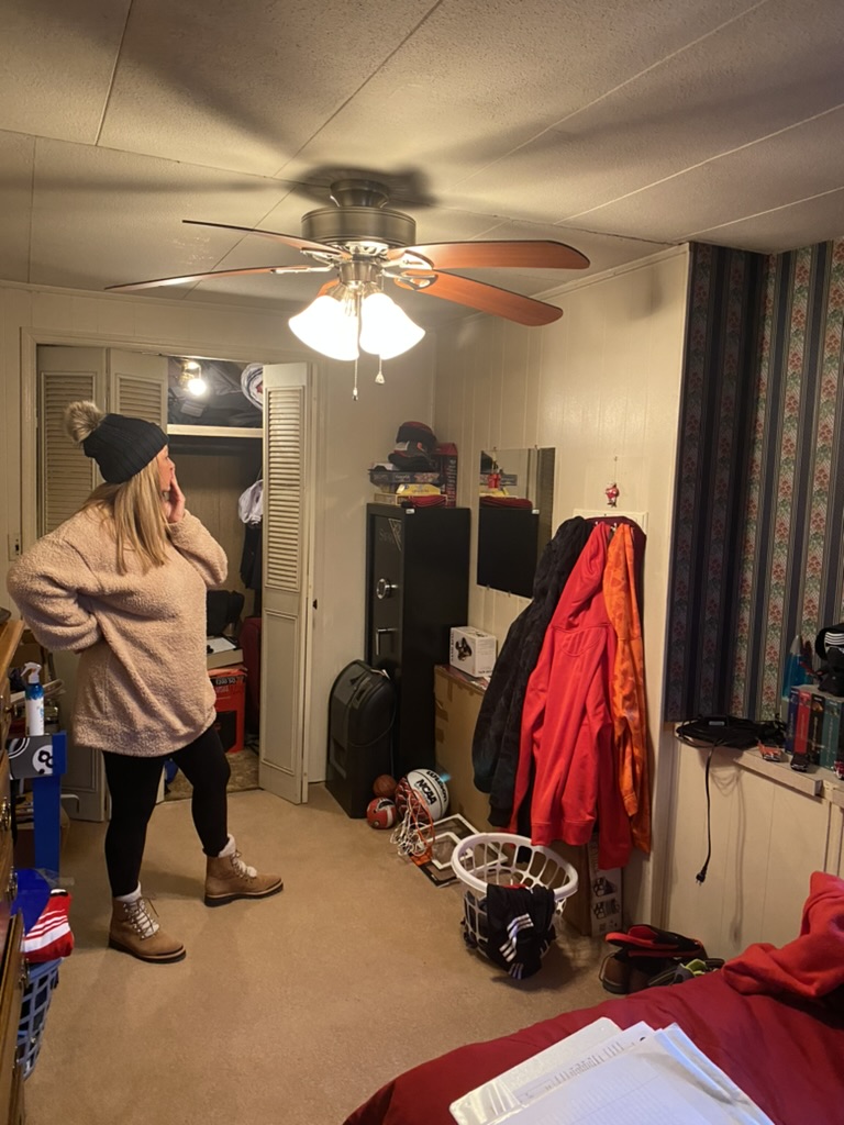 A volunteer walking through a child’s bedroom before its RRGA transformation begins.