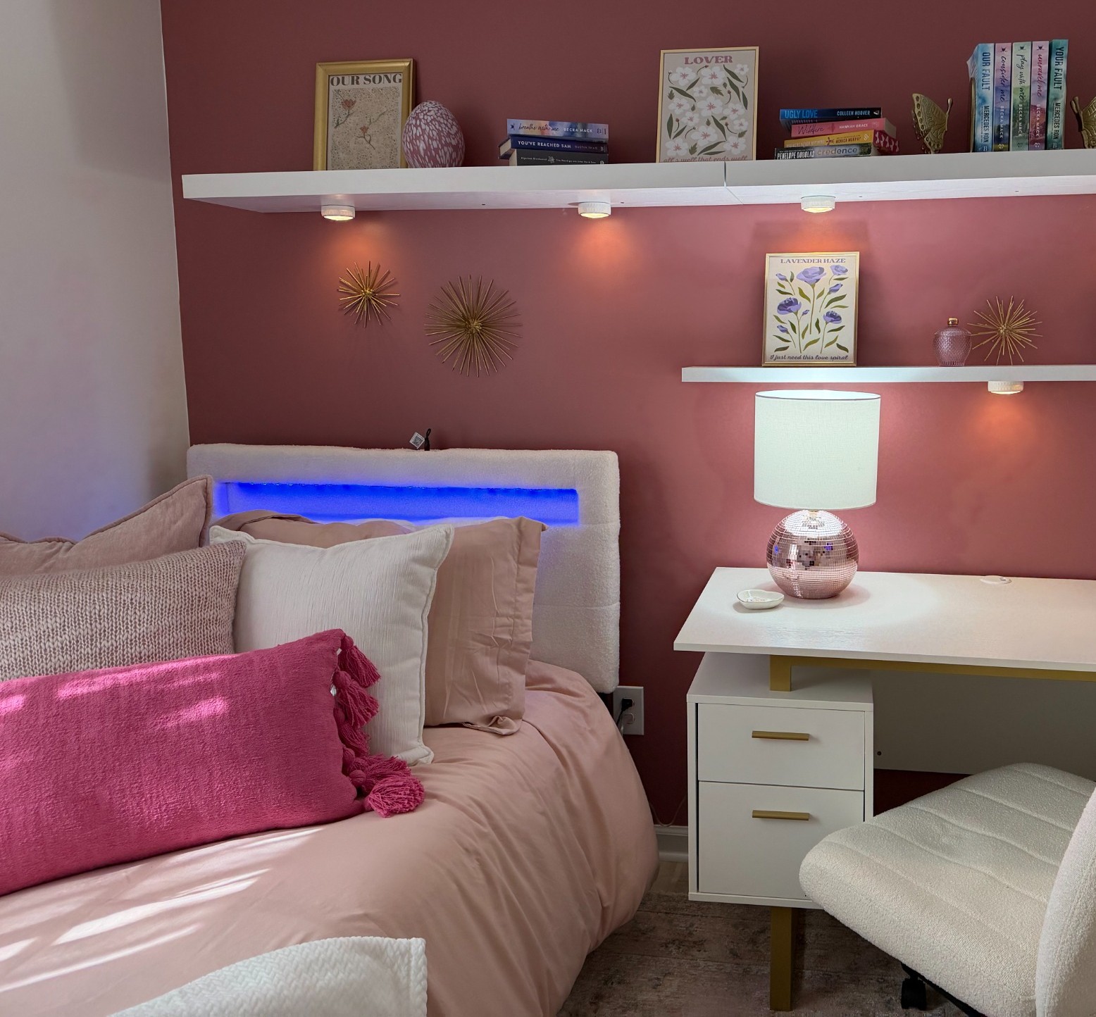 Completed pink and white RRGA bedroom with a new bed, desk, shelving, lighting and personalized décor.