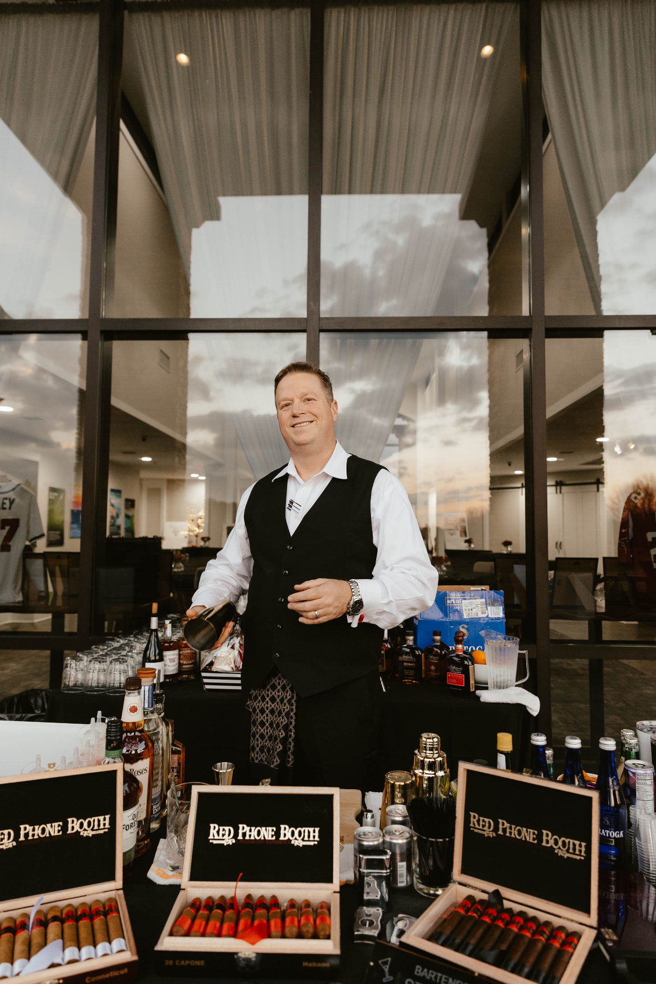 A bartender behind the Red Phone Booth bar at the Lady in Red Gala.