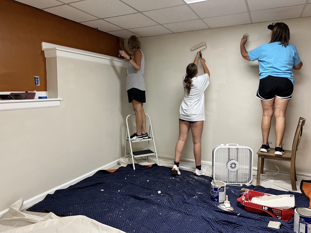 Volunteers installing wall décor.